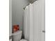 Bathroom featuring a white shower curtain, toilet, and a floral print poster at 3317 Sweetleaf Ln, Buford, GA 30519