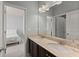Bathroom featuring a large vanity with dual sinks and two doors leading into the bedroom and hallway at 3317 Sweetleaf Ln, Buford, GA 30519