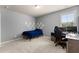 Comfortable bedroom featuring neutral walls, carpet floors, and a desk with computer monitors at 3317 Sweetleaf Ln, Buford, GA 30519