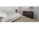 Cozy bedroom with a small bed, carpeted floors, and a dresser against the wall at 3317 Sweetleaf Ln, Buford, GA 30519