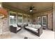Relaxing covered patio with comfortable seating and a ceiling fan, ideal for outdoor entertaining at 3317 Sweetleaf Ln, Buford, GA 30519