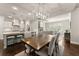 Open concept dining area adjacent to kitchen boasts modern lighting and neutral colors at 3317 Sweetleaf Ln, Buford, GA 30519