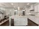 Bright kitchen with large center island, stainless steel appliances, ample cabinetry and pendant lights at 3317 Sweetleaf Ln, Buford, GA 30519