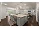 Open kitchen featuring a large island, stainless steel appliances, and views of the living room at 3317 Sweetleaf Ln, Buford, GA 30519