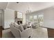 Bright living room with stone fireplace, large windows, and neutral decor at 3317 Sweetleaf Ln, Buford, GA 30519