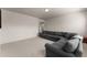 A spacious living room with carpeted floors and a large gray sectional at 3317 Sweetleaf Ln, Buford, GA 30519