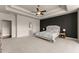 Main bedroom features a tray ceiling, fan, accent wall, and plush carpeting at 3317 Sweetleaf Ln, Buford, GA 30519
