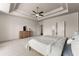 Bright primary bedroom featuring a tray ceiling, ceiling fan, and a large walk-in closet at 3317 Sweetleaf Ln, Buford, GA 30519