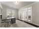 Office features built-in cabinetry, large windows, hardwood floors and glass french doors at 3317 Sweetleaf Ln, Buford, GA 30519