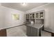 Cozy home office with built-in desk and cabinets, hardwood floor, and neutral paint at 3317 Sweetleaf Ln, Buford, GA 30519