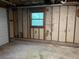Unfinished basement with concrete floor and small window for natural light at 743 San Fernando Se Dr, Smyrna, GA 30080