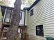 Two-story home featuring horizontal siding, dark-trim windows, and a lush, tree-filled yard at 743 San Fernando Se Dr, Smyrna, GA 30080