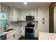 Beautiful kitchen with stainless steel appliances, white cabinets, and decorative backsplash at 743 San Fernando Se Dr, Smyrna, GA 30080
