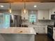 Modern kitchen features stainless steel appliances, white cabinetry, and a center island at 743 San Fernando Se Dr, Smyrna, GA 30080