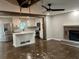 Open concept living room, flowing into a modern kitchen, features hardwood floors and a brick fireplace at 743 San Fernando Se Dr, Smyrna, GA 30080