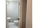 Small powder room has a pedestal sink and white marbled floors at 743 San Fernando Se Dr, Smyrna, GA 30080
