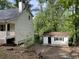 The backyard shows the rear of the house and the garage at 1978 Winding Creek Sw Ln, Marietta, GA 30064