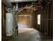 An unfinished basement with hot water tank and exposed ceiling at 1978 Winding Creek Sw Ln, Marietta, GA 30064