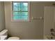 Bathroom features a window, toilet, and tub/shower combo at 1978 Winding Creek Sw Ln, Marietta, GA 30064