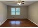 This spacious bedroom features warm wood flooring, neutral paint, and a sun-filled window at 1978 Winding Creek Sw Ln, Marietta, GA 30064