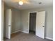 Bedroom features gray walls, carpet flooring, ceiling fan, and an open closet at 1978 Winding Creek Sw Ln, Marietta, GA 30064