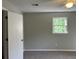 Bright bedroom featuring a window with green outside views, neutral paint and carpeted flooring at 1978 Winding Creek Sw Ln, Marietta, GA 30064