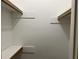 An open closet with a built in shelf and two wooden clothes rods at 1978 Winding Creek Sw Ln, Marietta, GA 30064