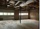 An unfinished multi-car garage with two access doors and exposed ceiling at 1978 Winding Creek Sw Ln, Marietta, GA 30064