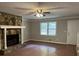 Bright living room with a stone fireplace as a focal point and a view to the front yard at 1978 Winding Creek Sw Ln, Marietta, GA 30064