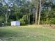 Large backyard has a storage shed and is surrounded by mature trees at 3831 Dillard St, Powder Springs, GA 30127