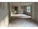Spacious living room boasts raw wood flooring, freshly prepared walls, and a window with a view of the yard at 3831 Dillard St, Powder Springs, GA 30127