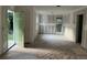 Open-concept living room boasts raw wood flooring, freshly prepared walls, and a doorway to the outside at 3831 Dillard St, Powder Springs, GA 30127
