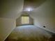 Spacious attic with neutral carpet and natural light from a window at 4801 Devonhurst Way, Powder Springs, GA 30127