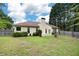 Spacious backyard with mature trees, grass, and wood fence at 4801 Devonhurst Way, Powder Springs, GA 30127