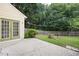 Backyard with patio, mature trees, privacy fence, and greenery at 4801 Devonhurst Way, Powder Springs, GA 30127