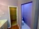 View of a bathroom featuring a closet and toilet with a lavender paint scheme at 4801 Devonhurst Way, Powder Springs, GA 30127