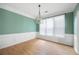 Dining area with large windows, chair rail, and modern chandelier at 4801 Devonhurst Way, Powder Springs, GA 30127