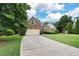Exterior view of home with driveway, garage, and green lawn at 4801 Devonhurst Way, Powder Springs, GA 30127