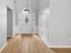 Bright foyer with hardwood floors, wainscoting, and a decorative front door at 4801 Devonhurst Way, Powder Springs, GA 30127