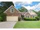 Inviting brick home with green shutters and a lush green lawn at 4801 Devonhurst Way, Powder Springs, GA 30127