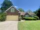 Charming brick home featuring a well-manicured lawn and a two-car garage in a quiet neighborhood at 4801 Devonhurst Way, Powder Springs, GA 30127