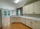 Bright kitchen with white cabinets, countertops, and modern appliances at 4801 Devonhurst Way, Powder Springs, GA 30127