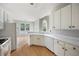 Bright kitchen showcasing light cabinets, wood floors, and a breakfast nook at 4801 Devonhurst Way, Powder Springs, GA 30127