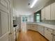 Well-lit kitchen features white cabinets, modern appliances, and an open layout at 4801 Devonhurst Way, Powder Springs, GA 30127