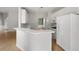 Open kitchen with a breakfast bar and white appliances overlooking the living area at 4801 Devonhurst Way, Powder Springs, GA 30127