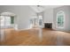 Spacious living room featuring a fireplace, hardwood floors, and arched windows at 4801 Devonhurst Way, Powder Springs, GA 30127