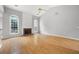 Bright and airy living room featuring hardwood floors and a brick fireplace at 4801 Devonhurst Way, Powder Springs, GA 30127