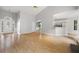 Open-concept living room with hardwood floors and views into the kitchen area at 4801 Devonhurst Way, Powder Springs, GA 30127