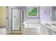 Well-lit ensuite bathroom with a shower, tub, and vanity at 4801 Devonhurst Way, Powder Springs, GA 30127