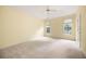 Spacious main bedroom with carpet flooring, a ceiling fan, and large windows at 4801 Devonhurst Way, Powder Springs, GA 30127